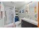Bright bathroom featuring a stand-up shower, single sink vanity, and artwork at 520 Lafayette Blvd, Oldsmar, FL 34677