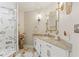 Bathroom features a shower with marble wall tiles, a vanity, and decorative lighting at 520 Lafayette Blvd, Oldsmar, FL 34677