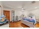 Charming bedroom with hardwood floors features a crib and bed with detailed, plush linens at 520 Lafayette Blvd, Oldsmar, FL 34677