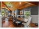 Open concept dining room with a wooden ceiling, and stylish furniture with views to the living room at 520 Lafayette Blvd, Oldsmar, FL 34677