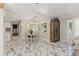Bright dining room area with marble floors, chandelier and a seamless flow into the main living space at 520 Lafayette Blvd, Oldsmar, FL 34677