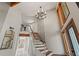 Grand entryway featuring a staircase with metal accents, contemporary design and natural light at 520 Lafayette Blvd, Oldsmar, FL 34677