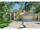 Beautiful two-story home with attached two-car garage, lush landscaping, and lovely brick and siding exterior at 520 Lafayette Blvd, Oldsmar, FL 34677