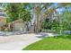 View of the side of a home including an oversized detached garage with updated doors and a well-manicured lawn at 520 Lafayette Blvd, Oldsmar, FL 34677