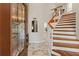 Inviting foyer featuring marble floors, an ornate door and a stairway with hardwood steps and modern railing at 520 Lafayette Blvd, Oldsmar, FL 34677
