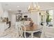 Modern eat-in kitchen with stainless steel appliances, marble floors and view to outdoor living space at 520 Lafayette Blvd, Oldsmar, FL 34677