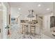 Open-concept kitchen with island seating, flowing seamlessly into the living and dining areas at 520 Lafayette Blvd, Oldsmar, FL 34677