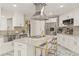 Well-appointed kitchen featuring white cabinets, stainless steel appliances, and marble island at 520 Lafayette Blvd, Oldsmar, FL 34677