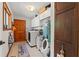 Functional laundry room with modern appliances, storage cabinets, and tile flooring at 520 Lafayette Blvd, Oldsmar, FL 34677