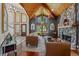 Inviting living room featuring wood ceilings, stone fireplace, and large windows with natural light at 520 Lafayette Blvd, Oldsmar, FL 34677