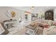 Bright open-plan living room features stylish decor, marble floors, and seamless flow to kitchen and dining areas at 520 Lafayette Blvd, Oldsmar, FL 34677