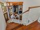 View from staircase of open concept living room with fireplace and wood-beamed ceilings at 520 Lafayette Blvd, Oldsmar, FL 34677
