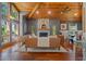 Spacious living room with stone fireplace, hardwood floors, wood beam ceiling, and modern furnishings at 520 Lafayette Blvd, Oldsmar, FL 34677