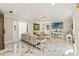 Bright living room with marble floors, coffered ceiling, comfortable sofa and large TV at 520 Lafayette Blvd, Oldsmar, FL 34677