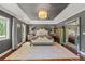 Spacious main bedroom with tray ceilings, chandelier and ample natural light at 520 Lafayette Blvd, Oldsmar, FL 34677