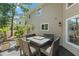 Inviting outdoor seating area, enhanced by the home's neutral siding and mature shade trees at 520 Lafayette Blvd, Oldsmar, FL 34677