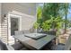 Covered patio with a stone dining table and six chairs, perfect for outdoor gatherings at 520 Lafayette Blvd, Oldsmar, FL 34677