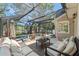 Spacious screened-in patio featuring comfortable seating, a ceiling fan, and an outdoor dining area at 520 Lafayette Blvd, Oldsmar, FL 34677