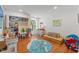 Large playroom includes a play area, sofas, and a world map rug on hardwood flooring at 520 Lafayette Blvd, Oldsmar, FL 34677