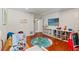 Spacious playroom with wood floors, furniture and TV entertainment area at 520 Lafayette Blvd, Oldsmar, FL 34677
