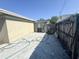 Private backyard with concrete patio, wooden fence, and utility hookups at 5316 Drift Tide Dr, New Port Richey, FL 34652