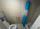Modest bathroom with blue shower curtain, standard toilet, and beige tile flooring at 5316 Drift Tide Dr, New Port Richey, FL 34652