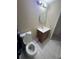 Bathroom featuring wood vanity, commode, and round mirror at 5316 Drift Tide Dr, New Port Richey, FL 34652