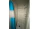 A well-lit, tiled shower area includes a rainfall shower head and a turquoise shower curtain at 5316 Drift Tide Dr, New Port Richey, FL 34652