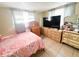 Cozy bedroom with light walls and tile floors at 5316 Drift Tide Dr, New Port Richey, FL 34652