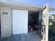 Garage with door partially open showing storage solutions and tools at 5316 Drift Tide Dr, New Port Richey, FL 34652