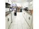 The kitchen features white cabinets, black hardware, granite countertops and stainless steel appliances at 5316 Drift Tide Dr, New Port Richey, FL 34652