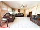 Spacious living room with neutral colors, ample natural light, and a ceiling fan at 5316 Drift Tide Dr, New Port Richey, FL 34652