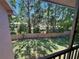 Screened patio offering a view of the fenced backyard with mature trees and green grass at 6410 Spring Flower Dr # 26, New Port Richey, FL 34653