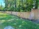 View of the backyard featuring green grass and a wooden fence at 6410 Spring Flower Dr # 26, New Port Richey, FL 34653