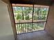 Screened in balcony featuring tile flooring overlooking lush green space at 6410 Spring Flower Dr # 26, New Port Richey, FL 34653