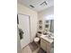 Bathroom featuring a toilet, vanity, mirror, and decor at 6410 Spring Flower Dr # 26, New Port Richey, FL 34653