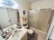 Bathroom featuring a shower-tub combo, toilet, vanity with a mirror, and decorative wall art at 6410 Spring Flower Dr # 26, New Port Richey, FL 34653