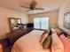 Bedroom with carpet, ceiling fan, and a view of the outdoors at 6410 Spring Flower Dr # 26, New Port Richey, FL 34653
