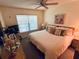 Comfortable bedroom featuring a ceiling fan, carpet, and natural light from the window at 6410 Spring Flower Dr # 26, New Port Richey, FL 34653