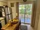 Kitchen area with access to balcony, stainless steel refrigerator and rolling island at 6410 Spring Flower Dr # 26, New Port Richey, FL 34653
