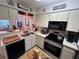 Functional kitchen with modern appliances, neutral cabinets, and an adjacent breakfast bar at 6410 Spring Flower Dr # 26, New Port Richey, FL 34653