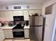 Updated kitchen features stainless steel appliances and white cabinets at 6410 Spring Flower Dr # 26, New Port Richey, FL 34653