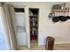 In-unit laundry area featuring stacked washer and dryer with storage space at 6410 Spring Flower Dr # 26, New Port Richey, FL 34653
