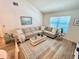 Well-lit living room with comfortable seating, modern decor, and a serene ambiance at 6410 Spring Flower Dr # 26, New Port Richey, FL 34653
