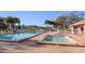 Outdoor community pool and spa area with brick-paved deck and lounge chairs for residents at 6410 Spring Flower Dr # 26, New Port Richey, FL 34653