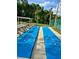 Shuffleboard courts for recreational enjoyment with benches, picnic table, and covered area at 6410 Spring Flower Dr # 26, New Port Richey, FL 34653