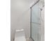 Bathroom with a toilet, tile flooring, and enclosed glass door shower at 658 Siren Wind Ln, Clearwater, FL 33756