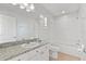 Clean bathroom featuring a granite countertop, vanity, toilet, tub and shower combination at 658 Siren Wind Ln, Clearwater, FL 33756