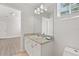 Bright bathroom featuring a granite countertop, vanity, toilet, and tile flooring at 658 Siren Wind Ln, Clearwater, FL 33756