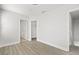 Open bedroom space with modern flooring, a walk-in closet, and an adjacent bathroom at 658 Siren Wind Ln, Clearwater, FL 33756